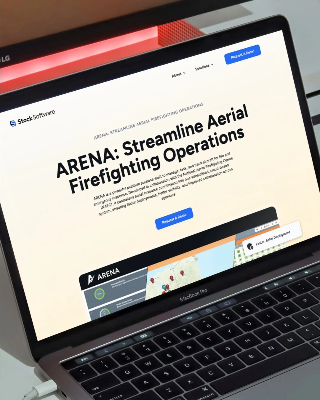 Laptop displaying a software website titled 'ARENA: Streamline Aerial Firefighting Operations' with a button labeled 'Request A Demo' and a map with location markers.