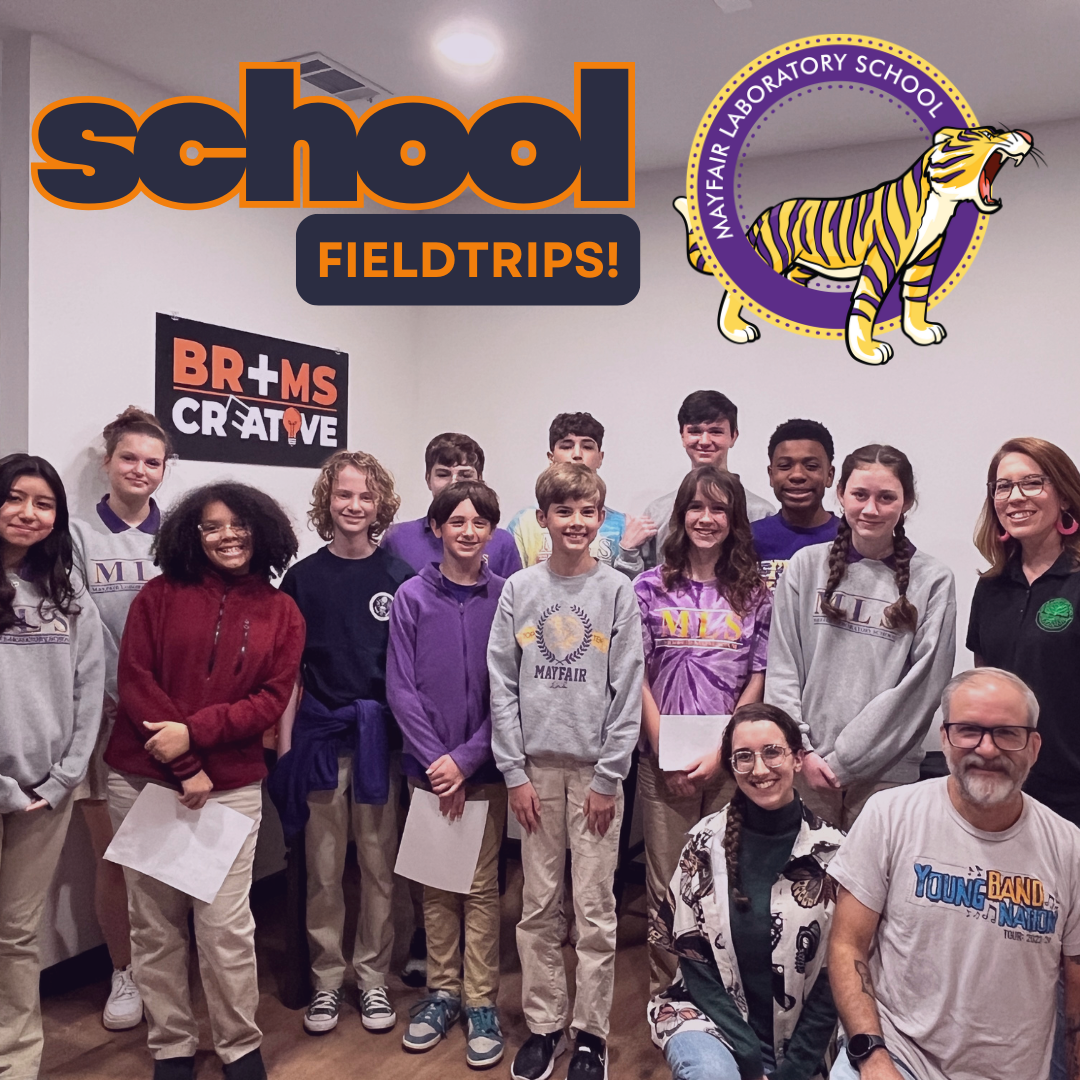 Group of middle school students and two adults at Mayfair Laboratory School, celebrating school field trips, with a Mayfair Laboratory School logo and a Mayfair CREATIVE sign in the background.
