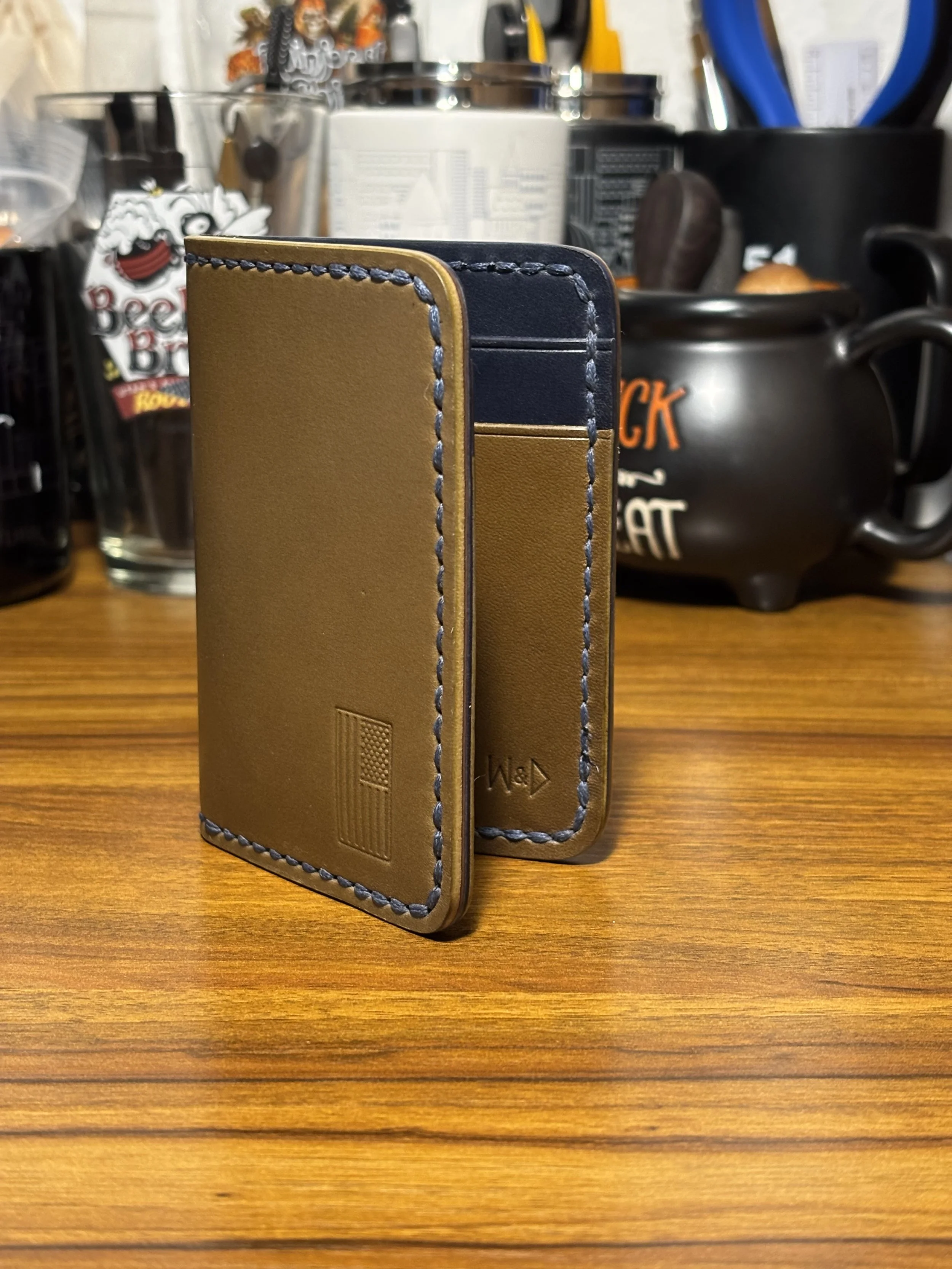 Handmade 1776 bifold wallet in olive green and navy blue Wickett & Craig English Bridle leather, hand saddle stitched in the USA.