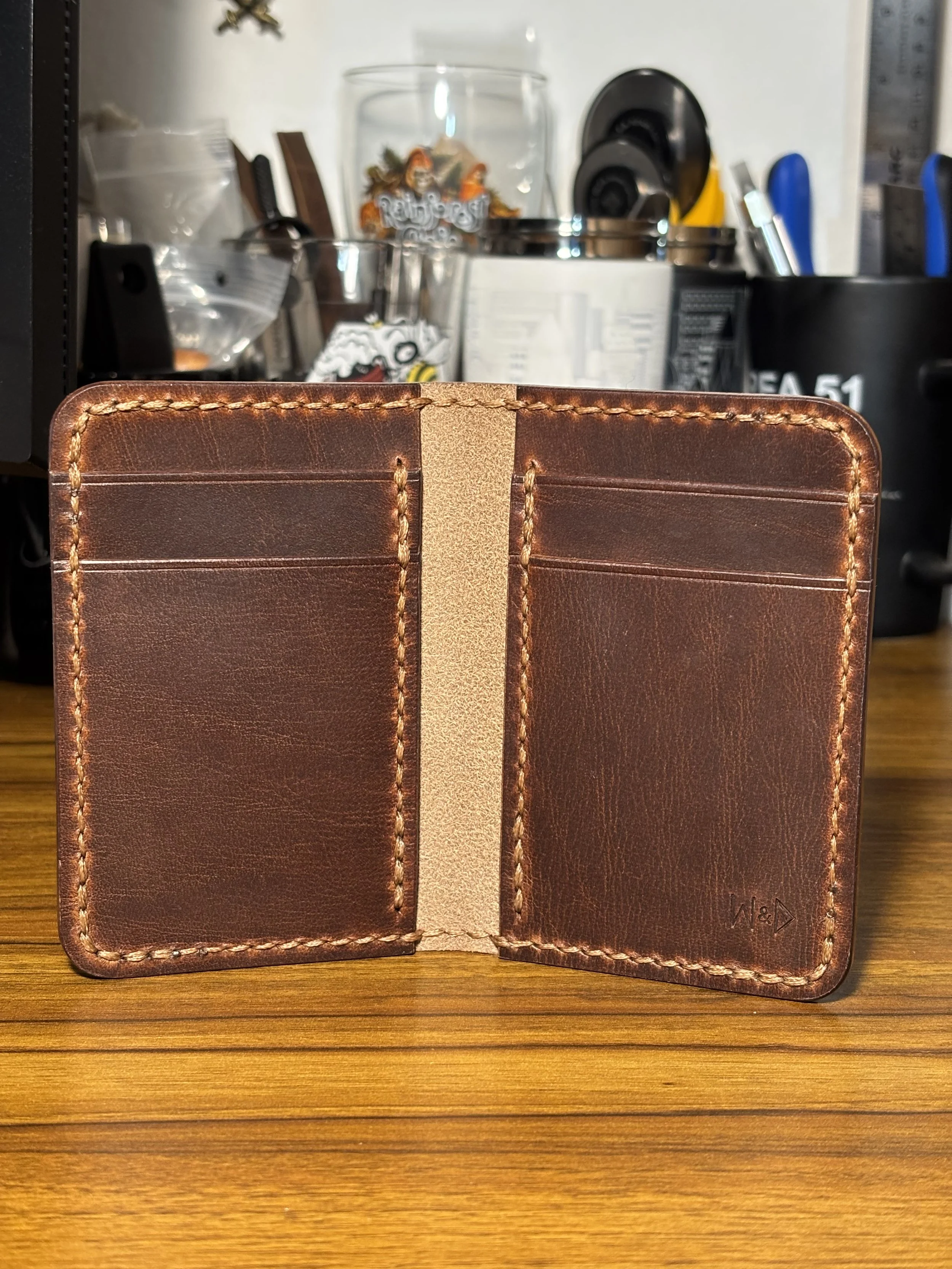 Open interior layout of The Cowboy Wallet showing Conceria La Bretagna leather card pockets and saddle stitching.