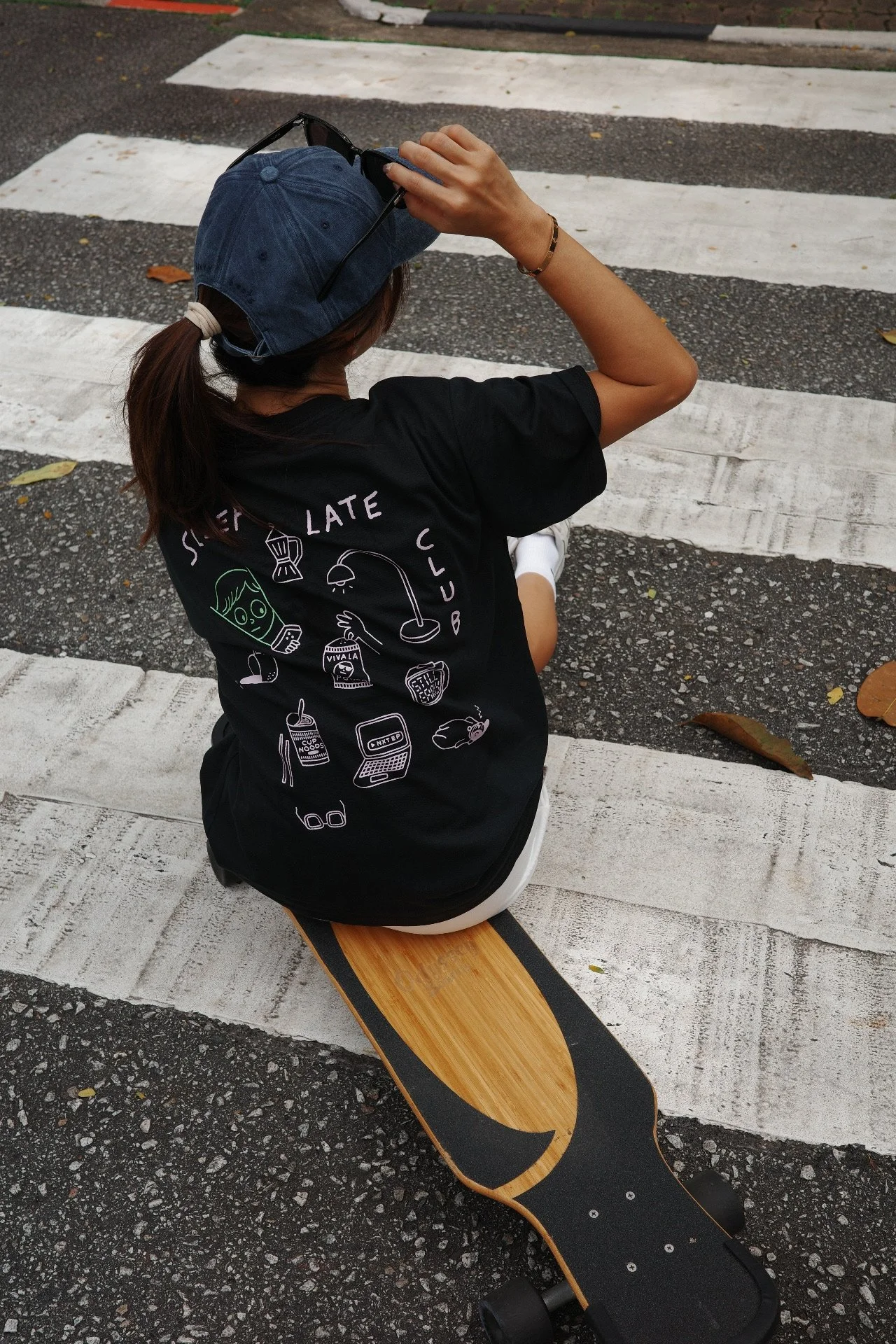 Back view of a black Sleep Late Club graphic t-shirt with pink and green graphics, unisex casual streetwear tee