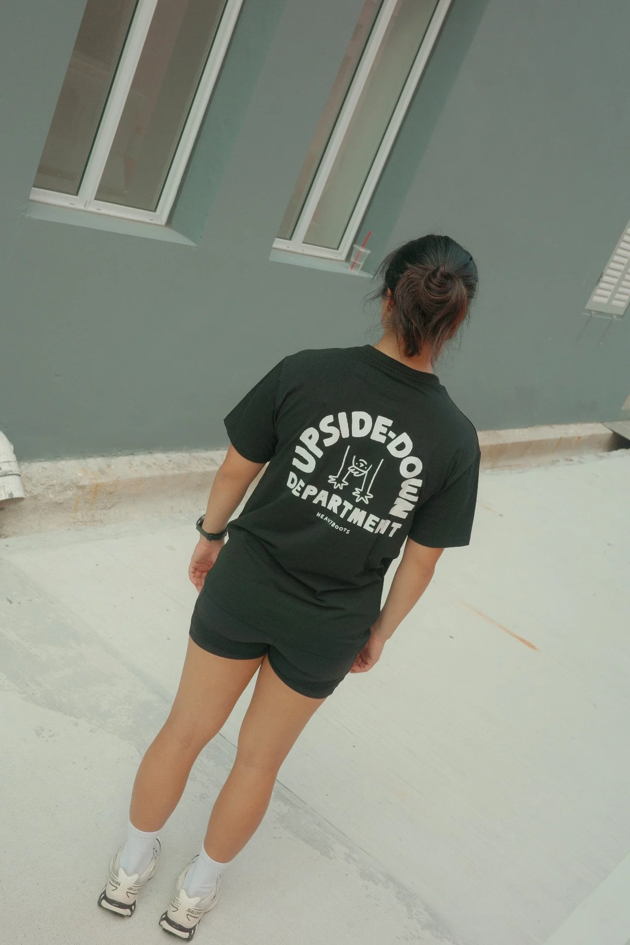 Back view of a black Upside Down Department graphic t-shirt with bold white graphics, unisex casual streetwear tee