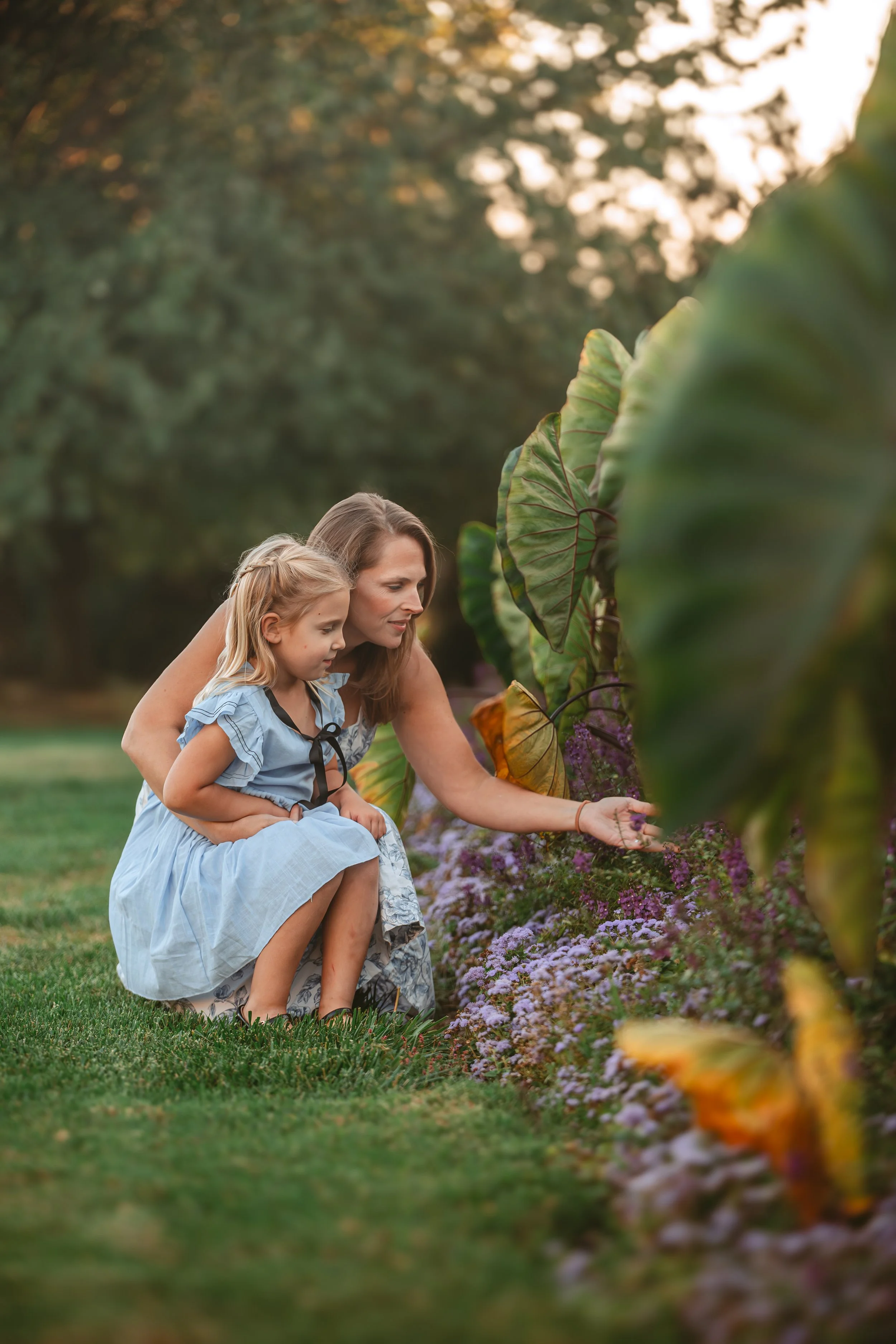 Mom and daughter looking at flowers 