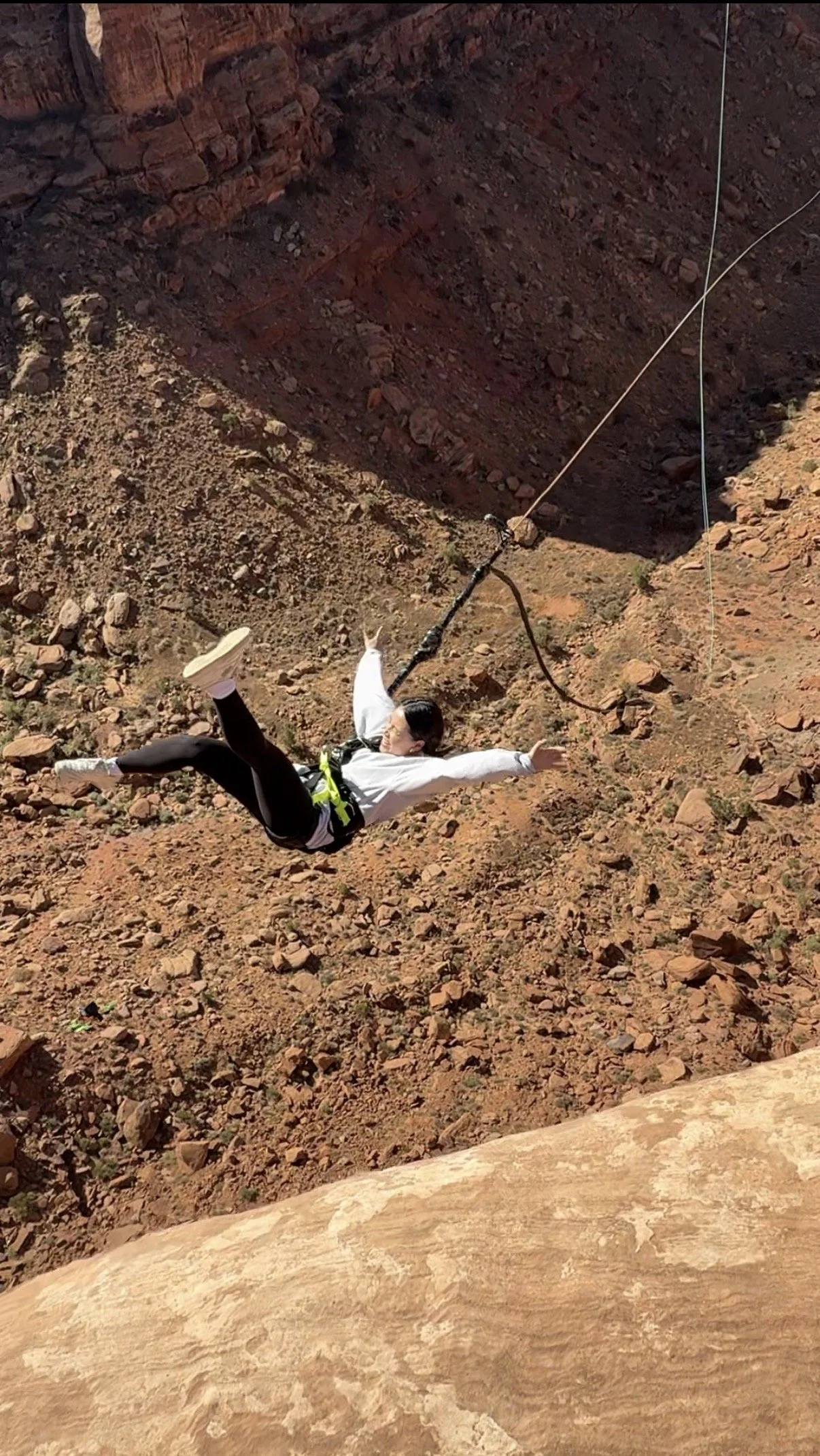 Getting tossed off a cliff with Moab Swingers. The biggest Rope Swing in Moab, UT! Discover the difference between Moab Swingers and other companies.