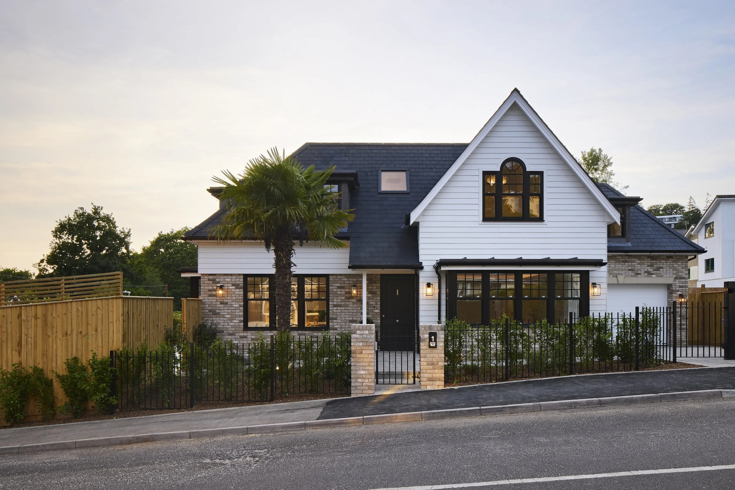 A new CGI render of a row of modern suburban houses located on the South Coast in Poole, Dorset with brick and white exteriors, surrounded by gardens, trees, and a paved driveway under a partly cloudy sky.