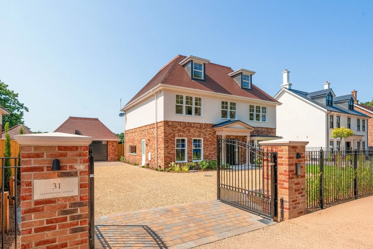 A new CGI render of a row of modern suburban houses located on the South Coast in Poole, Dorset with brick and white exteriors, surrounded by gardens, trees, and a paved driveway under a partly cloudy sky.