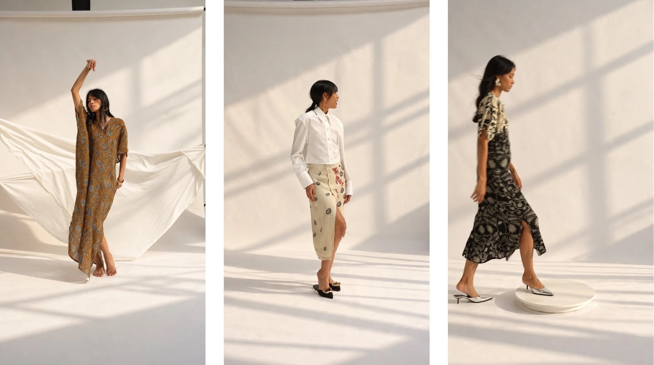 Three-panel series of a woman wearing HYPATIA Serat in hand-drawn Batik Tulis, soft window light: mustard-brown kaftan with blue-grey florals, white shirt with cream wrap skirt, black-and-cream dress.
