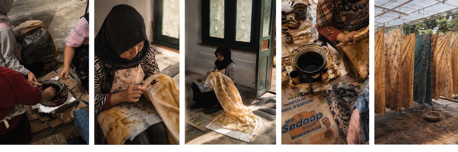 A five-panel process banner: artisans stirring dye, hand-applying wax with a canting tool to mustard-gold patterns, and hanging finished mustard-gold and indigo cloths to dry – hand-drawn wax-resist dyeing