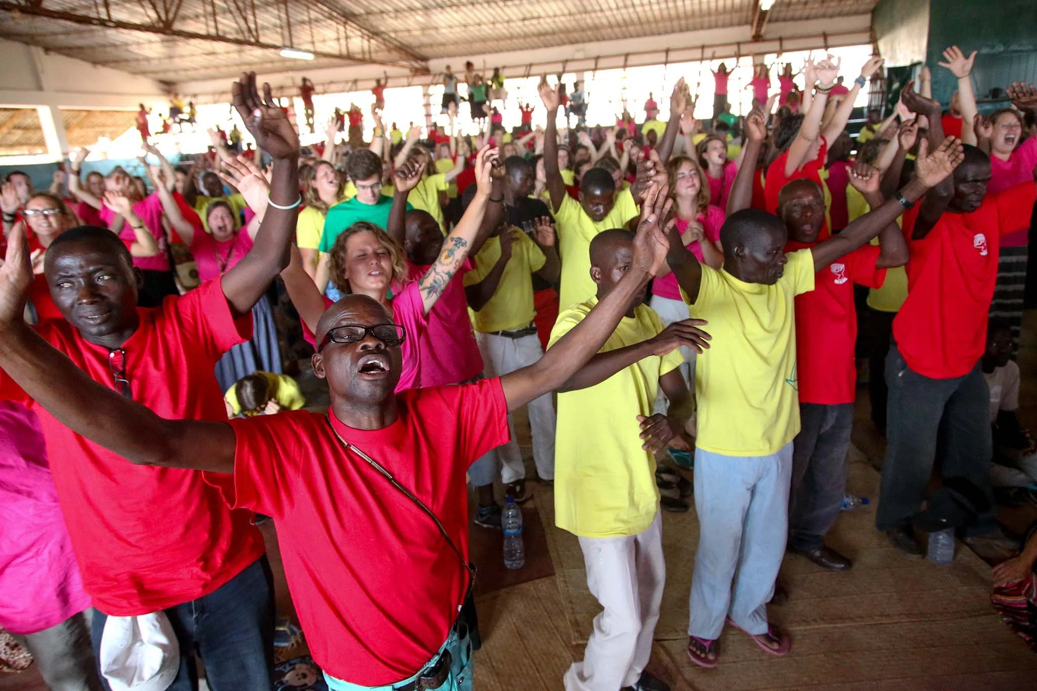 Bible school students worshiping at their graduation, along with Harvest School students