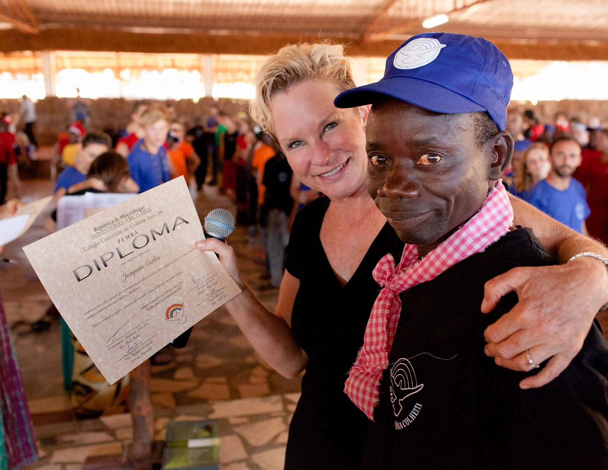 A thrilled pastor gets his Bible school certificate