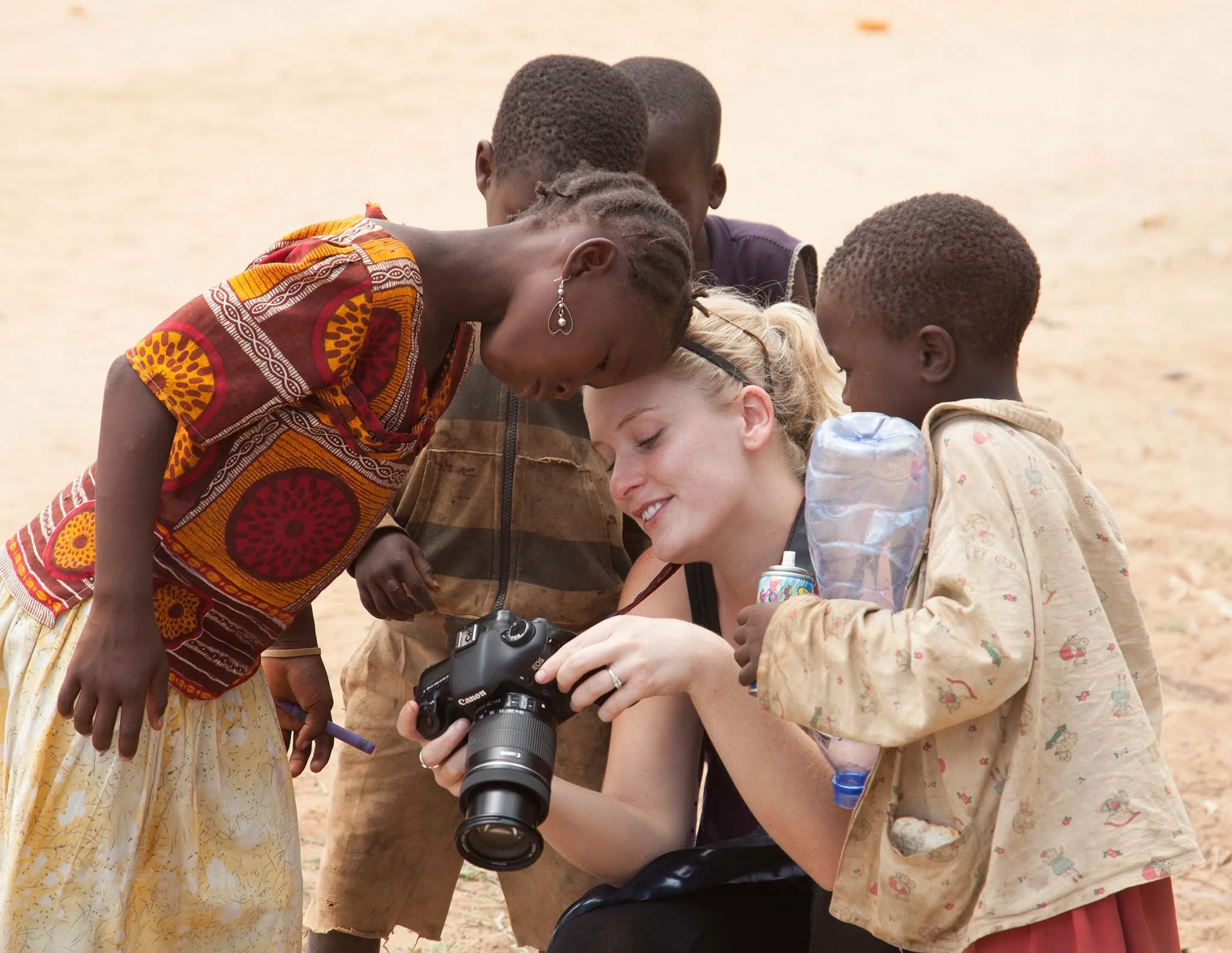 Kids intrigued by pictures on a camera