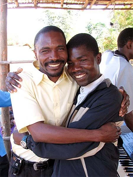 Surpresa, on the left, our Mozambican national director, hugging Franzie, our pastor who was beaten to death and then raised from the dead
