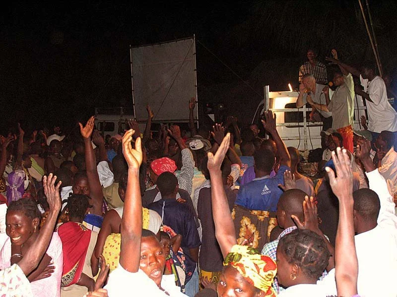 Excited response to Charles Stock's gospel message from a crowd of several thousand in a dark, very remote village in northern Mozambique