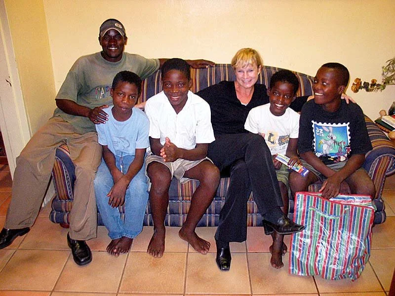 Heidi with very happy boys she just brought in from the streets, after giving them showers and clean clothes