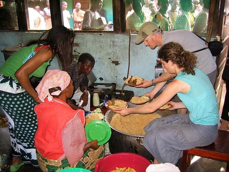 A visiting team helping in the kitchen on Children's Day