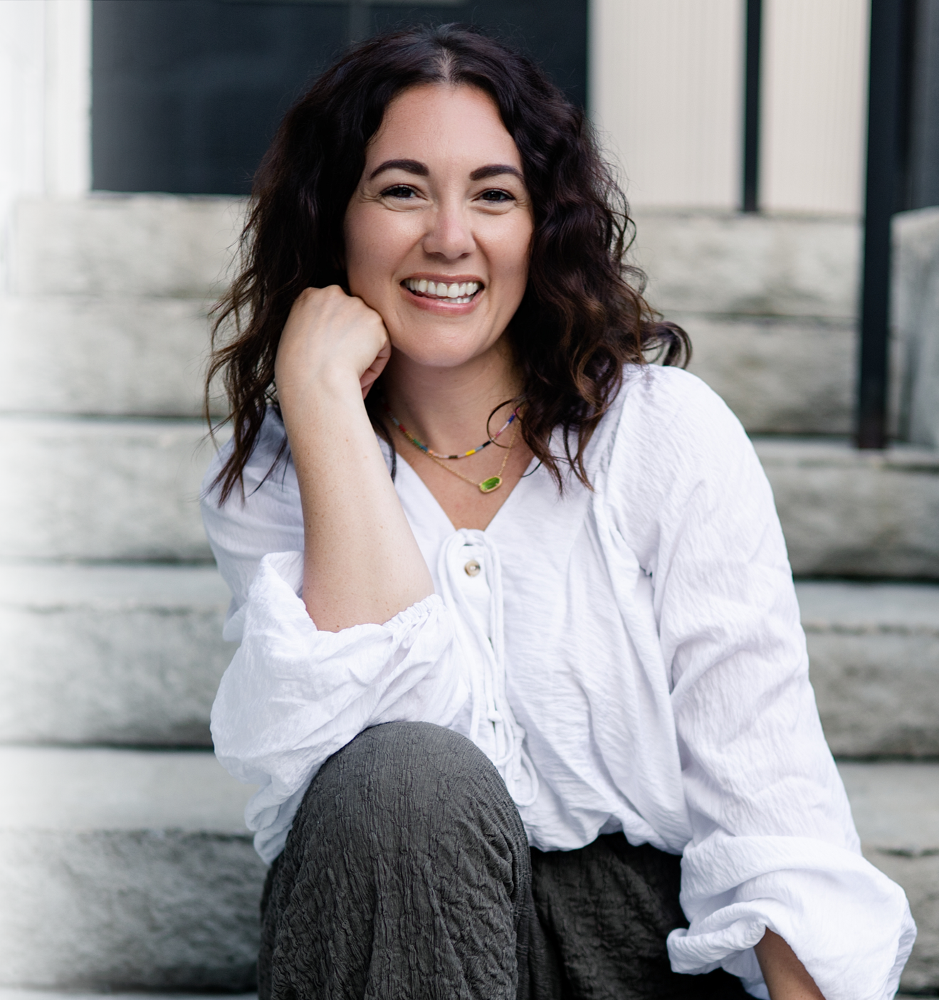 Mallory Tedrick seated outdoors and smiling