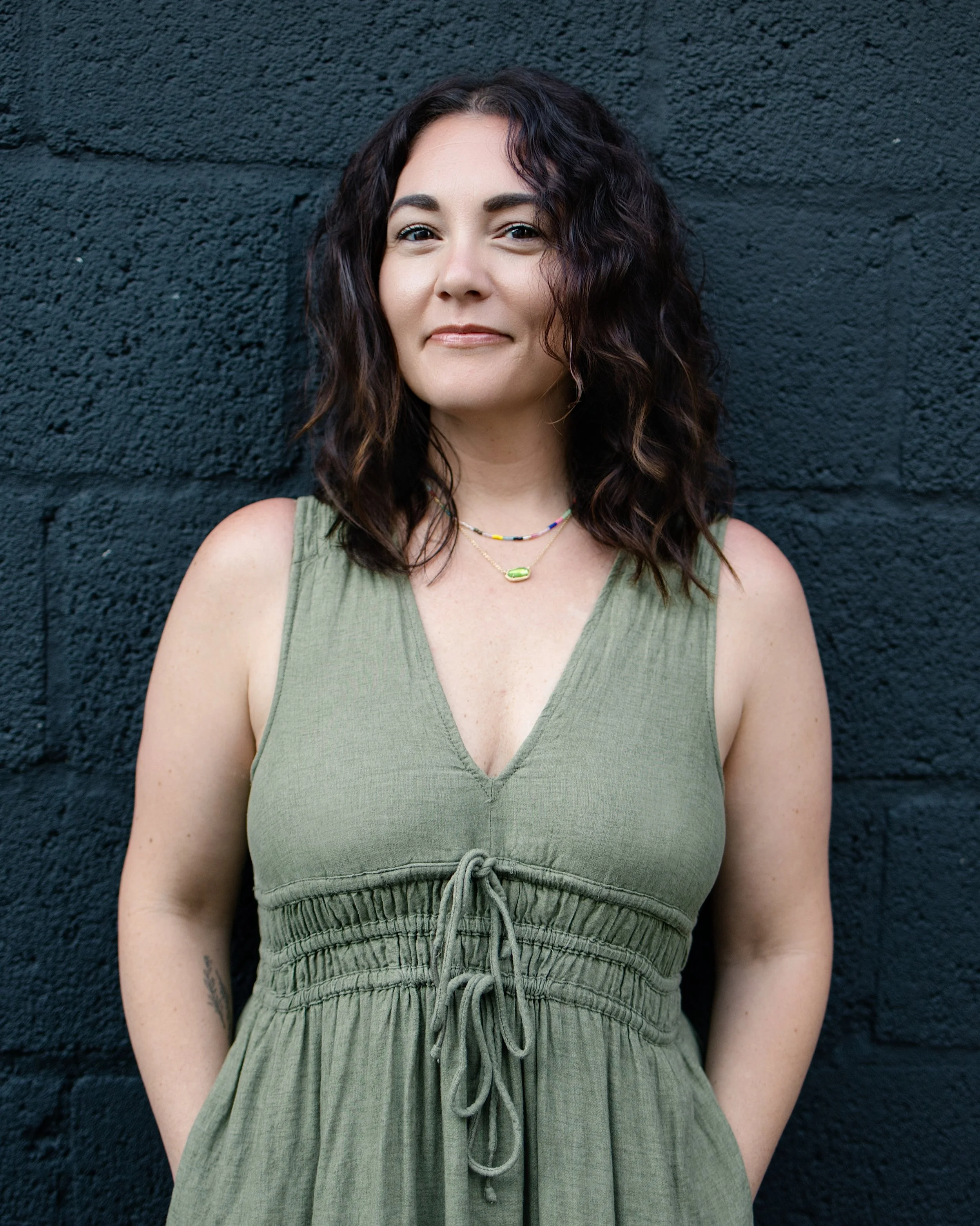 Mallory Tedrick standing outdoors in a green dress