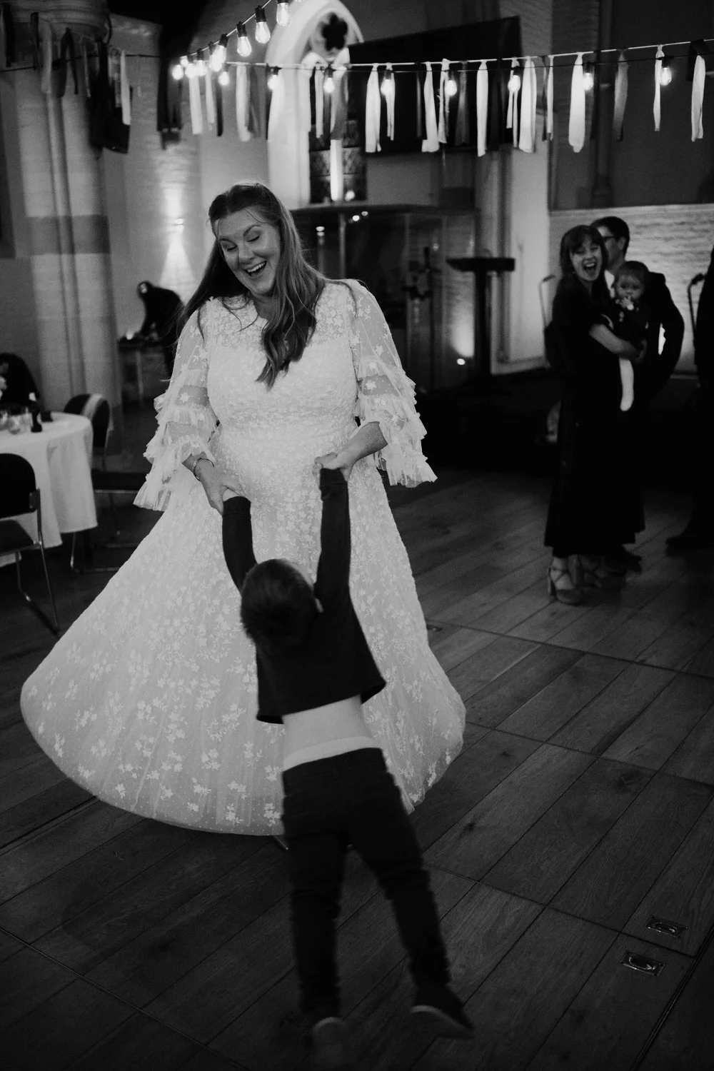 Bride dancing with a child during the evening celebration