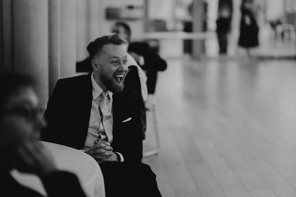 A guest laughing hard during the reception