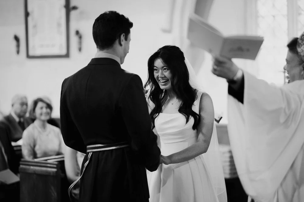 Bride and groom at the altar with guests watching