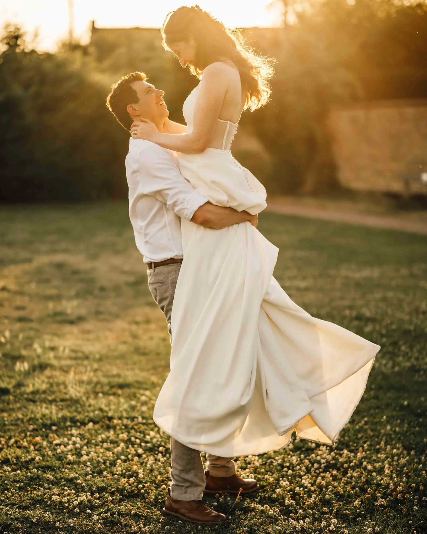 Couple walking across golden moorland at sunset