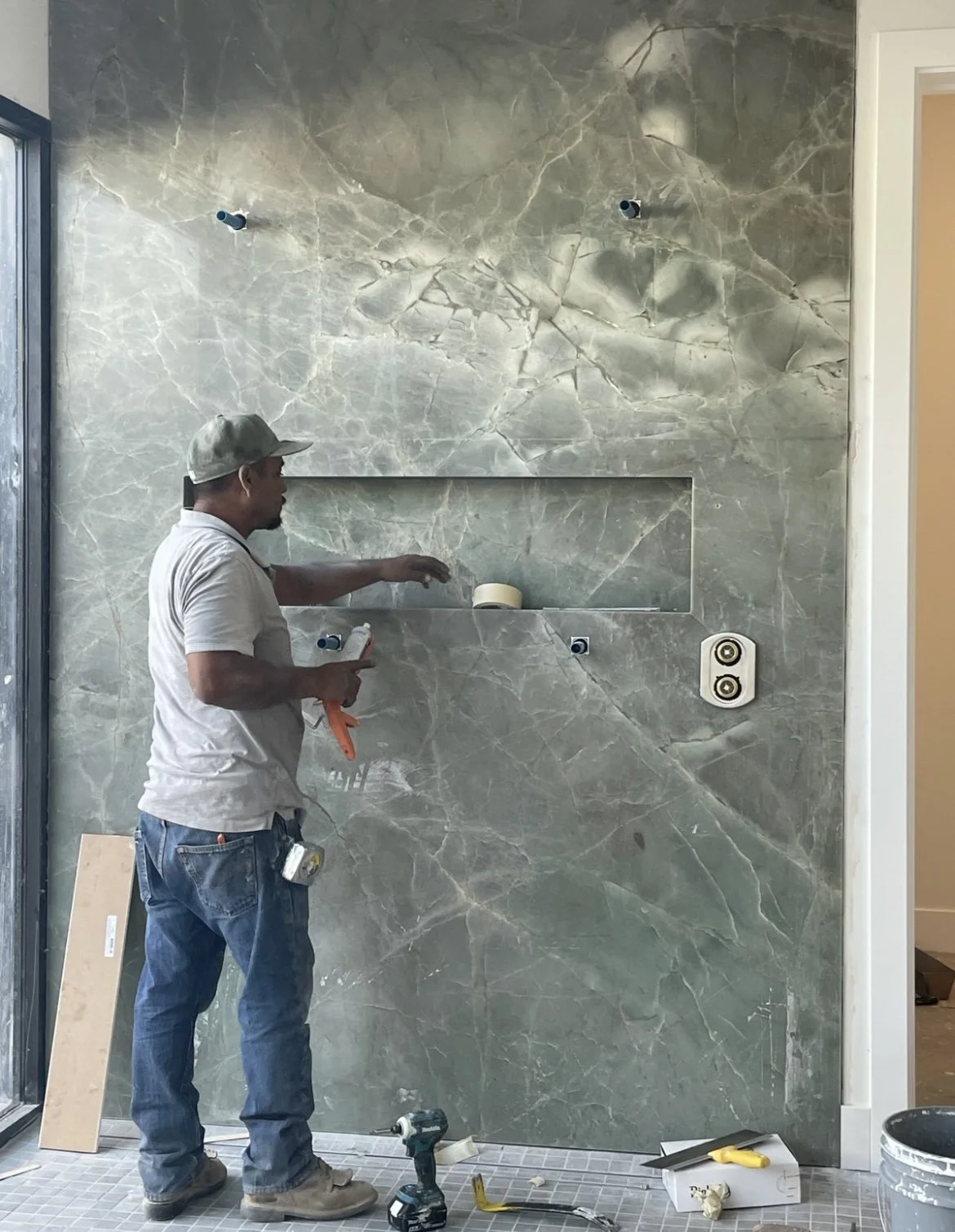 Fabricator Installing a full natural stone slab in a showroom.