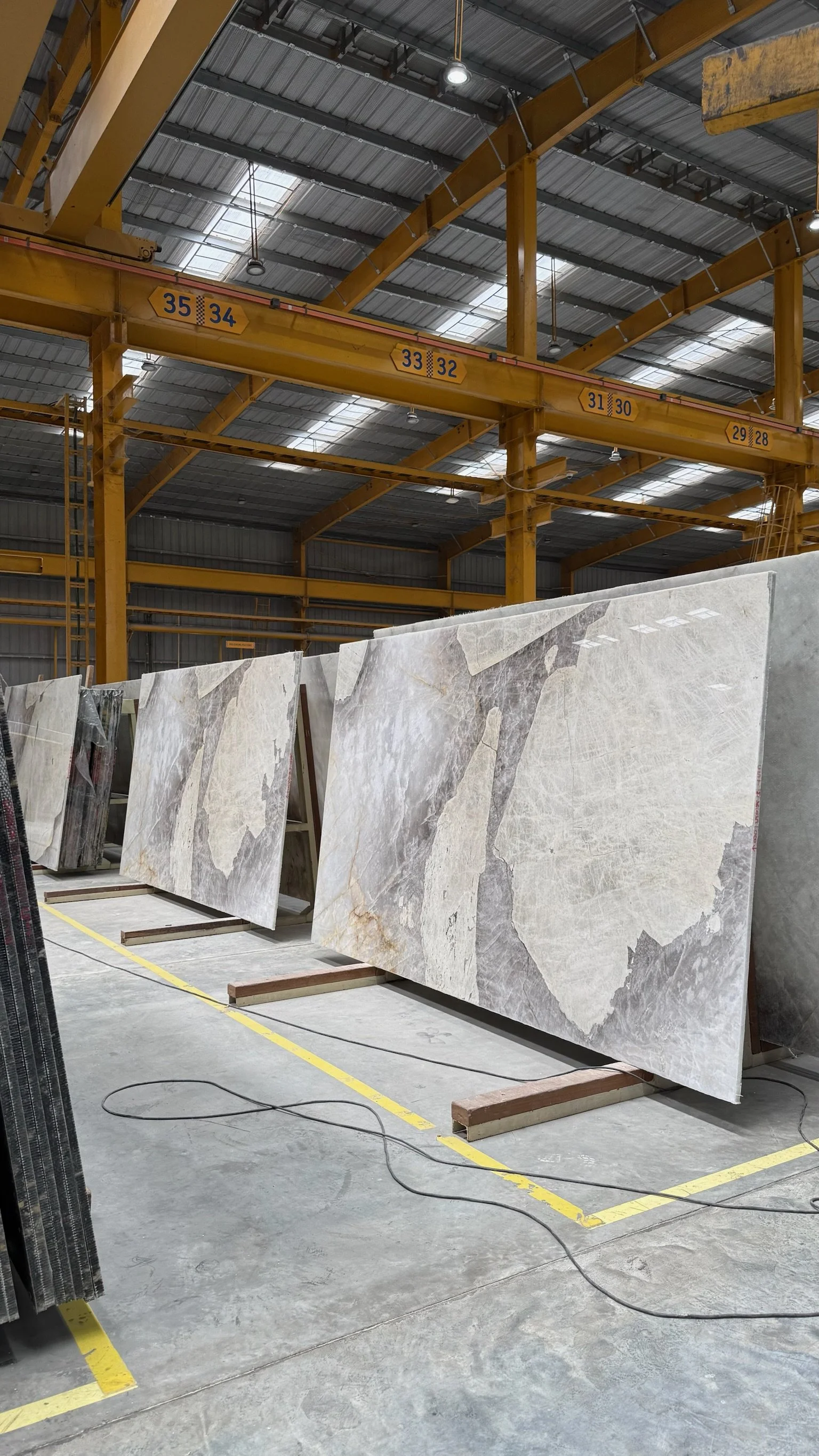 Multiple sequential natural stone slabs selected together for one project.