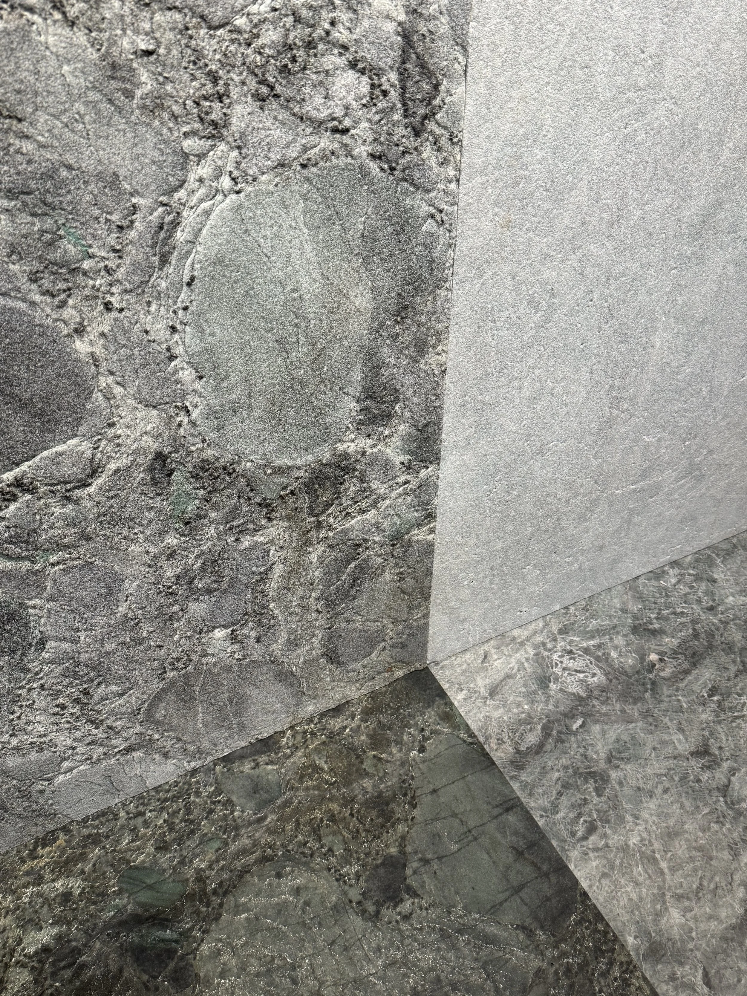 Two natural stone bundles of the same stone variety showing different veining and coloration.