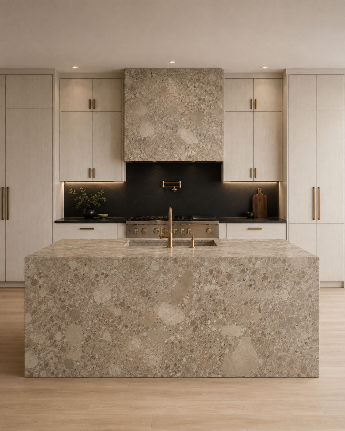 Natural stone kitchen design with marble clad range hood and slab backsplash