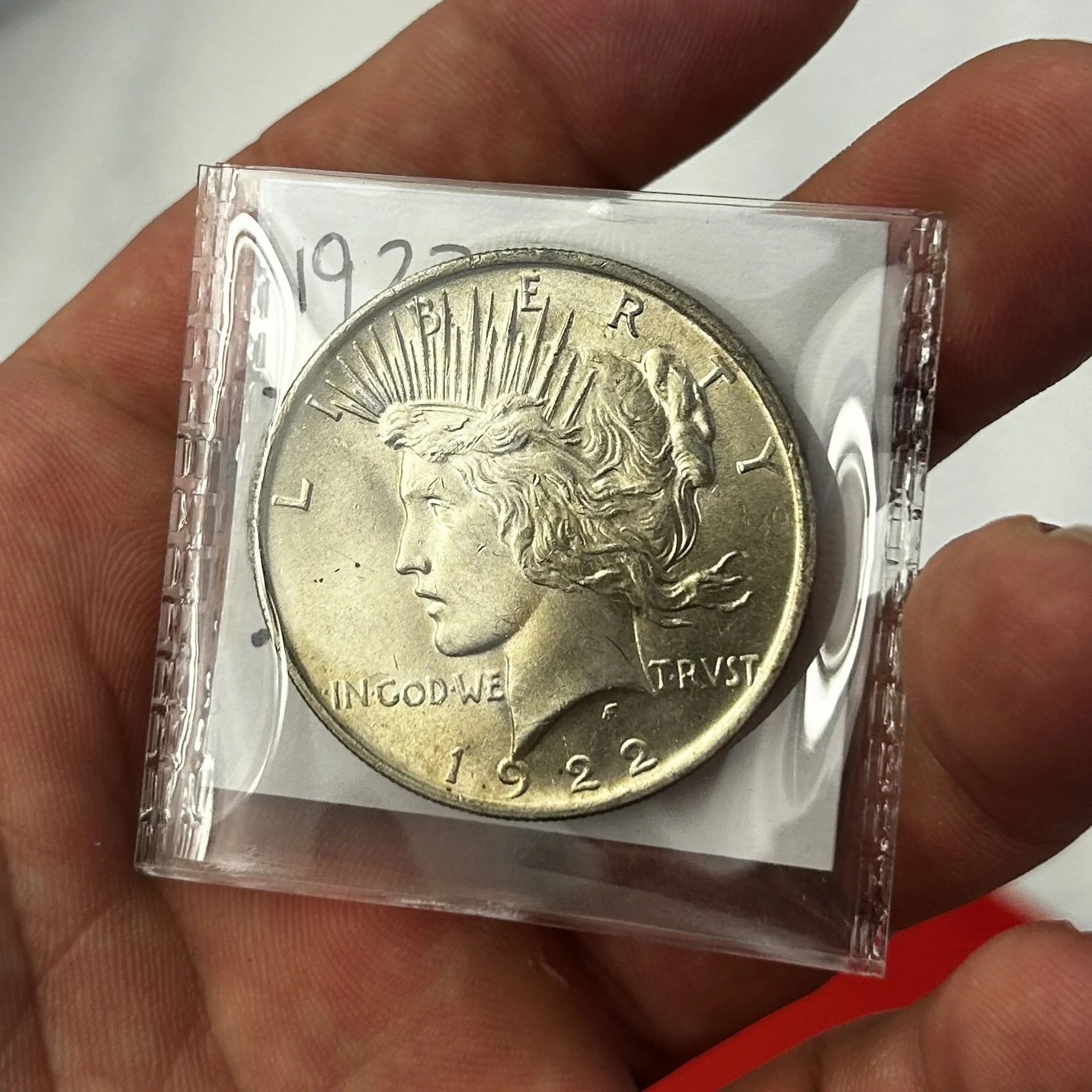 holding a silver dollar U.S. 1922 Peace Dollar Coin Liberty