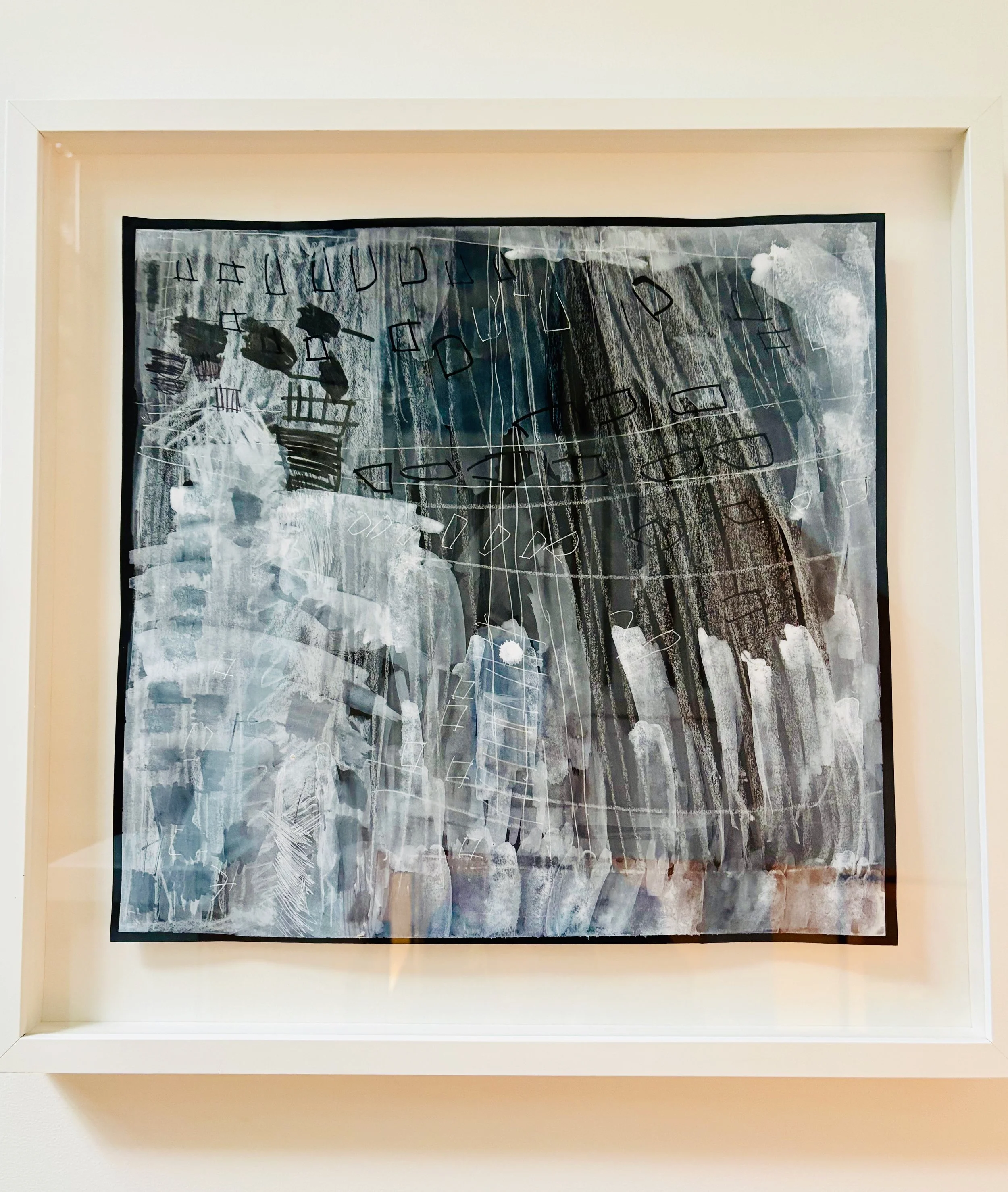 Abstract painting with white, black, and gray brushstrokes and lines framed in white.