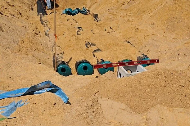 Leach field pipe layout during septic system installation