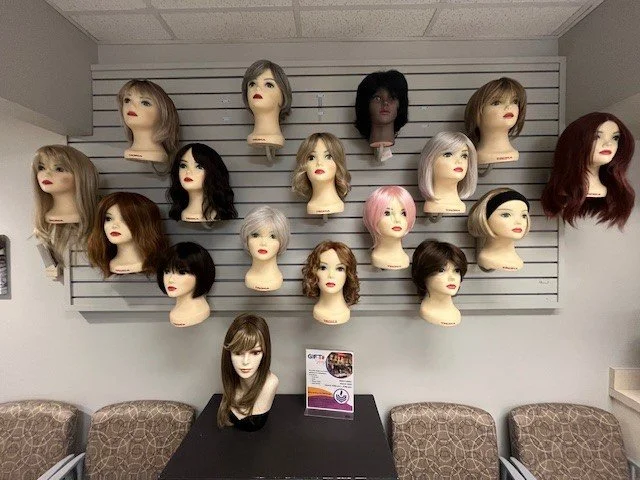 A variety of wigs on our display wall.