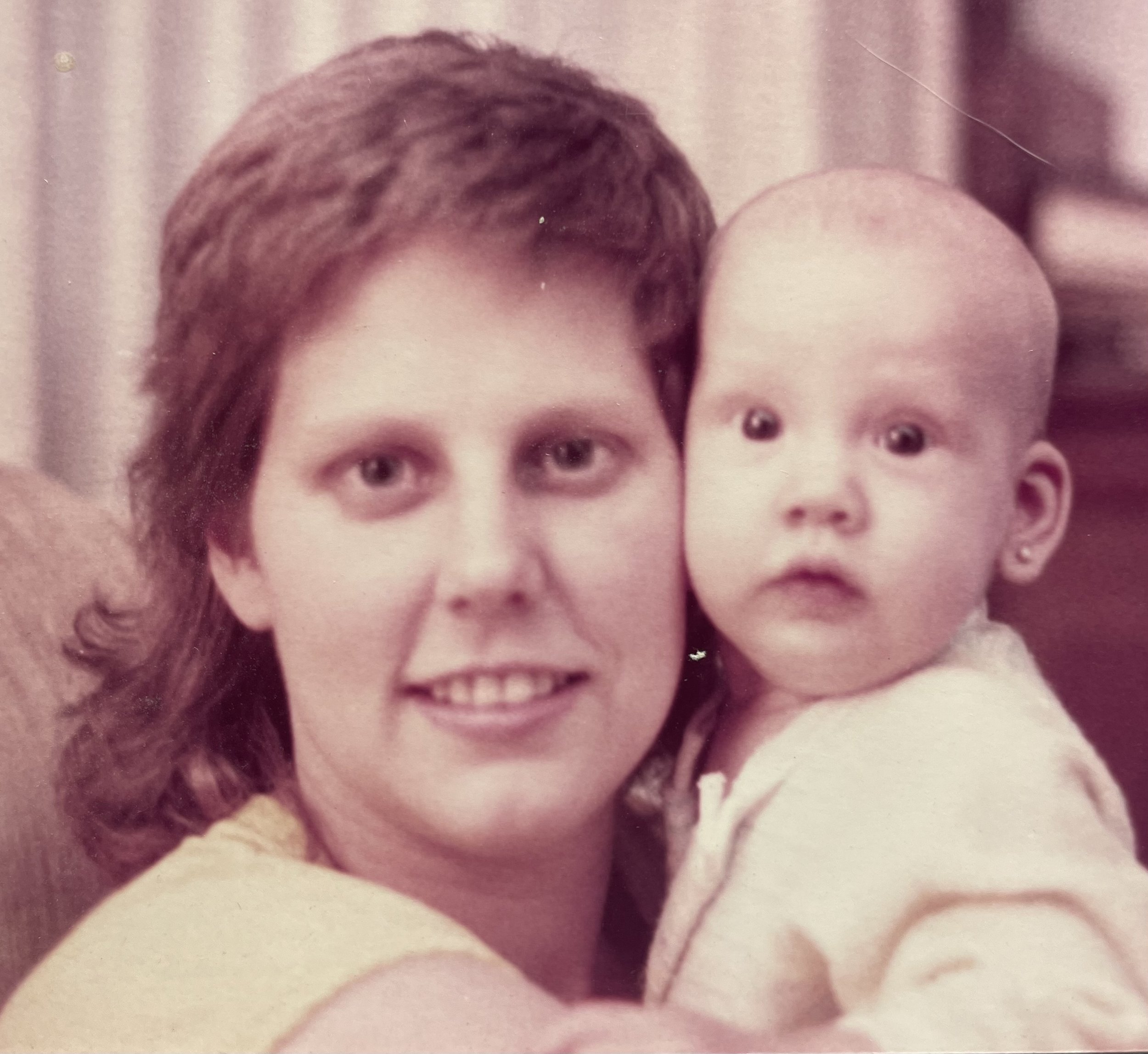 woman holding baby from the 1980's