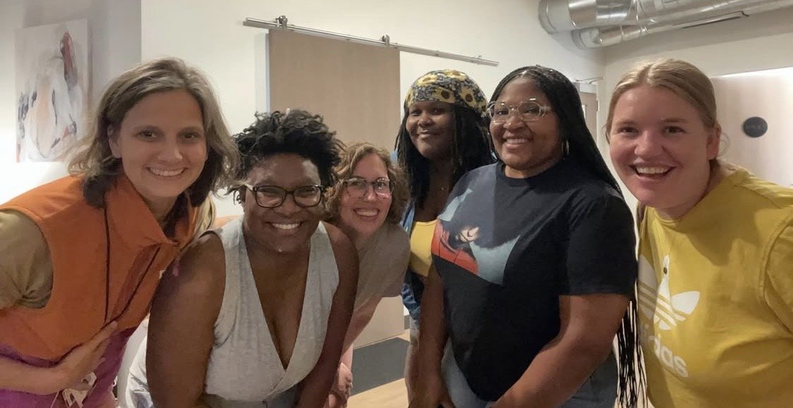 Group of doulas smiling, black and white women