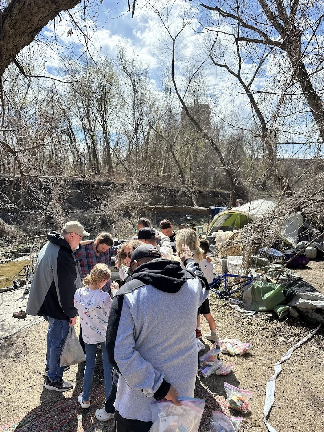 praying at homeless encampment.jpg