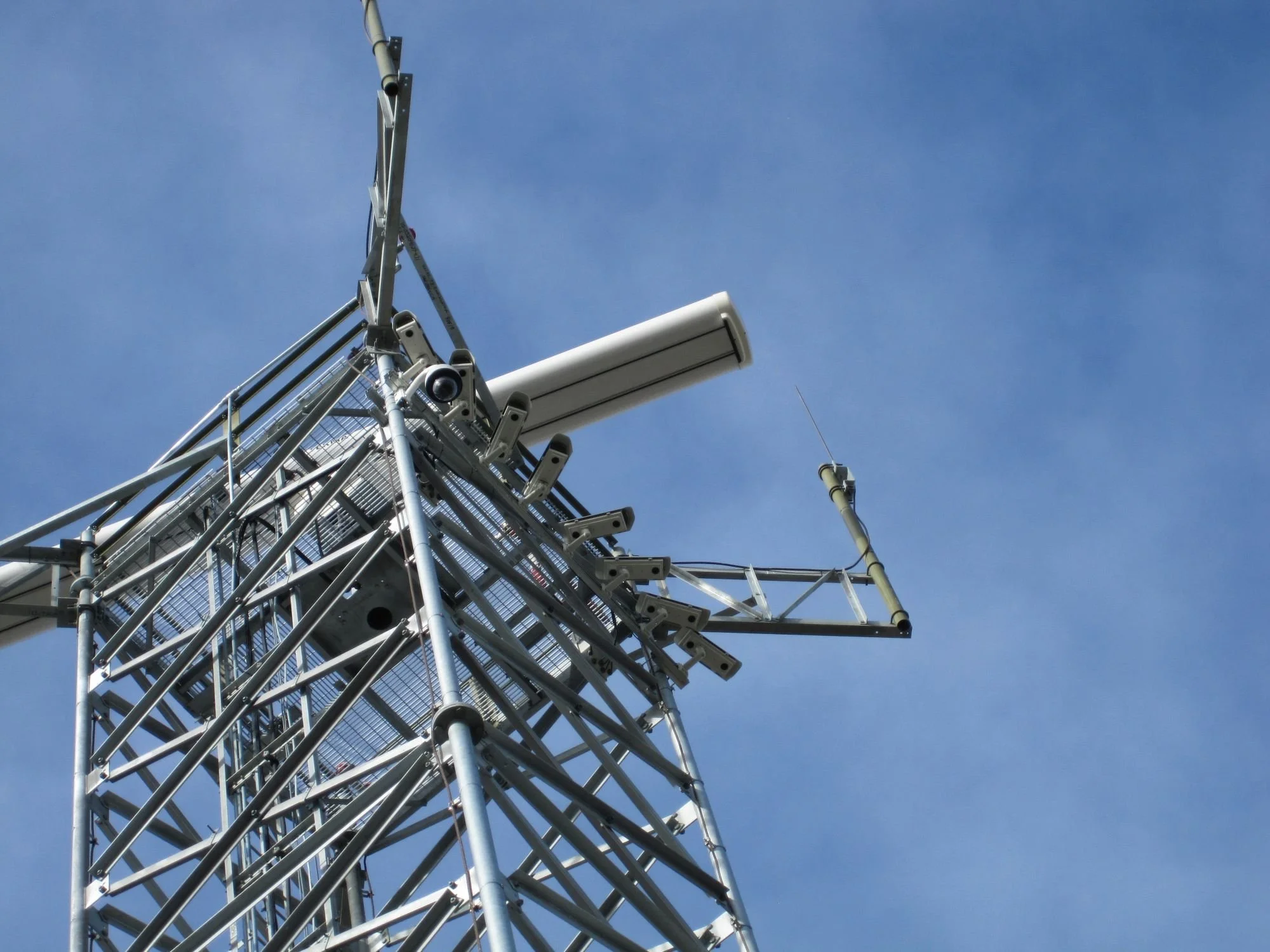 Surface movement radar tower with mounted surveillance cameras at airport