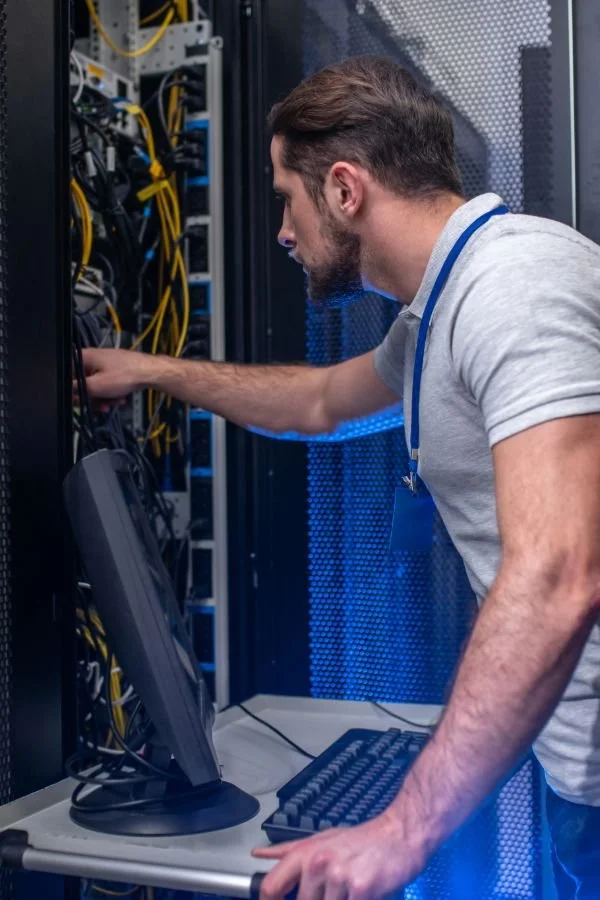 Systems engineer installing equipment onsite at airport airfield