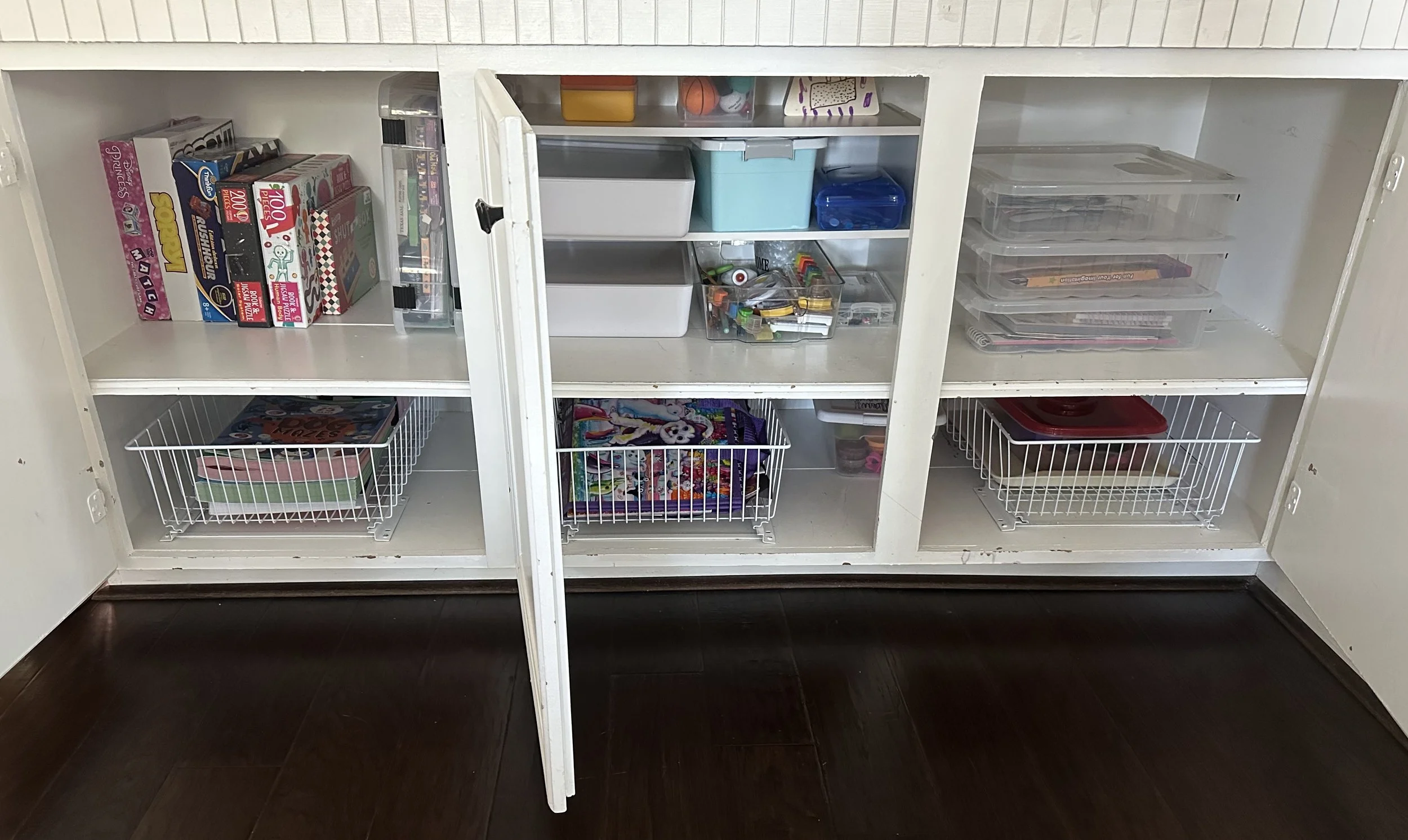 an organized playroom cabinet