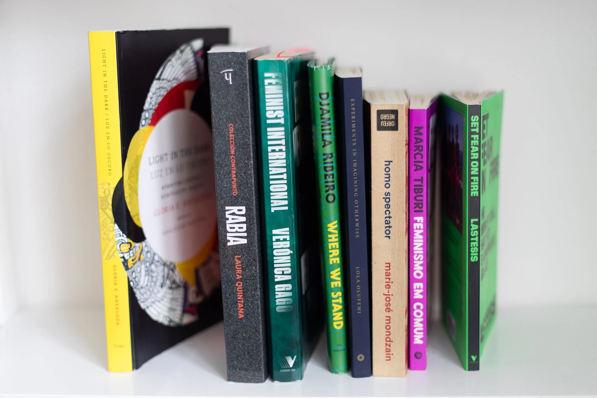 8 books photographed on a white book shelf