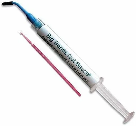 A syringe labeled 'Big Bends Nut Sauce' with a red applicator needle next to it.
