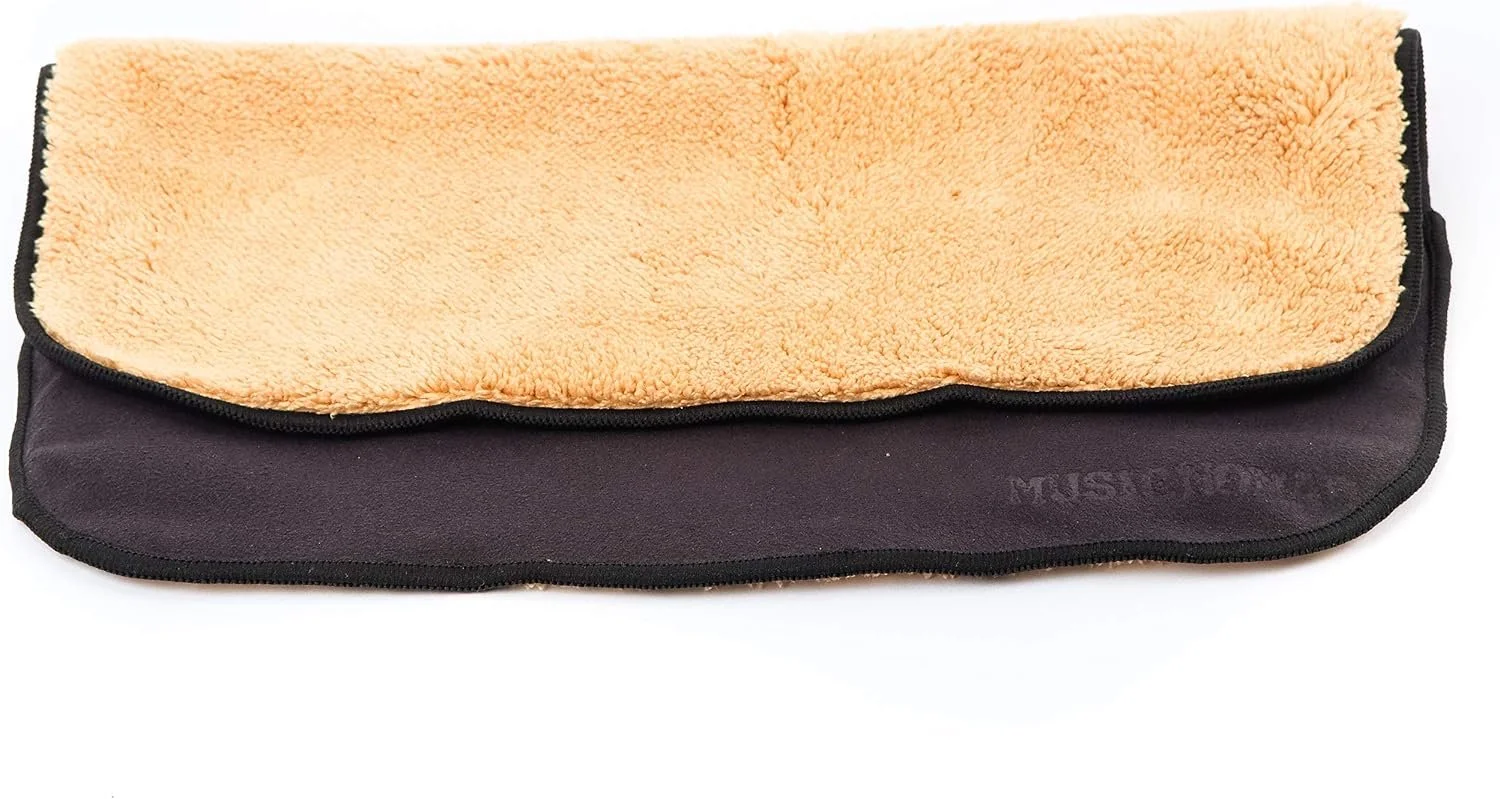 A rectangular black and tan microfiber cleaning cloth with a soft, plush tan surface and a black border.