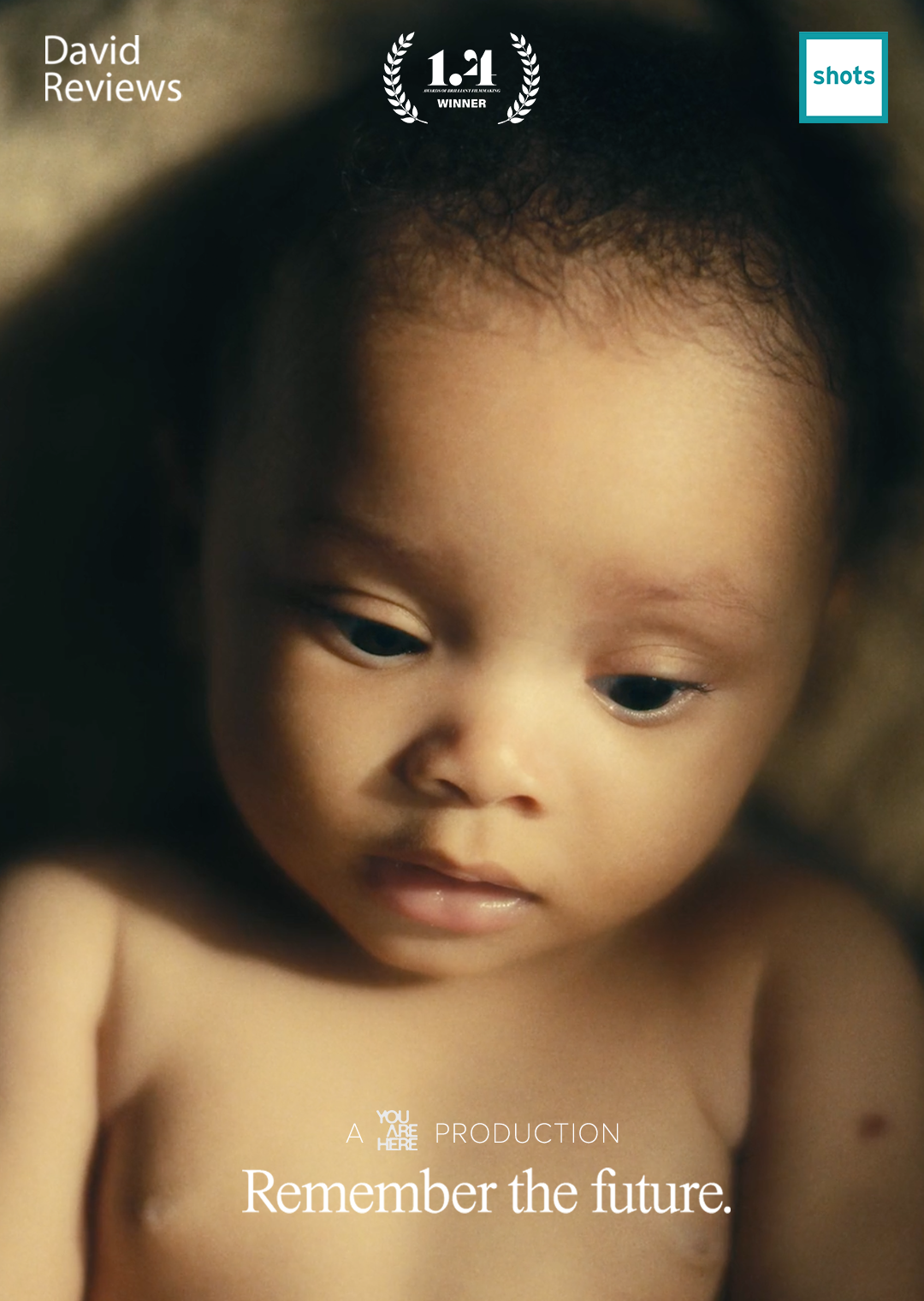 Close-up image of a young child with curly hair, looking downward, with text overlays including 'David Reviews', '1-1 WINNER', 'shots', and the phrase 'Remember the future.'