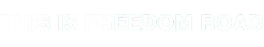 Text on a black background reads 'THIS IS FREEDOM ROAD' in white, bold letters.