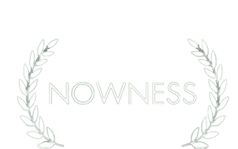 A logo with the text "NOWNESS" surrounded by a laurel wreath.