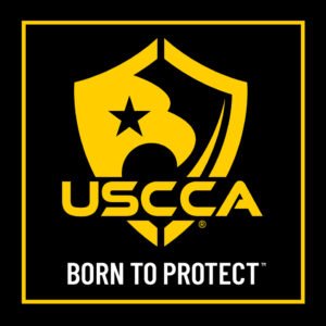 USCCA logo featuring a shield, star, and the text "USCCA Born to Protect" in black, yellow, and white colors.