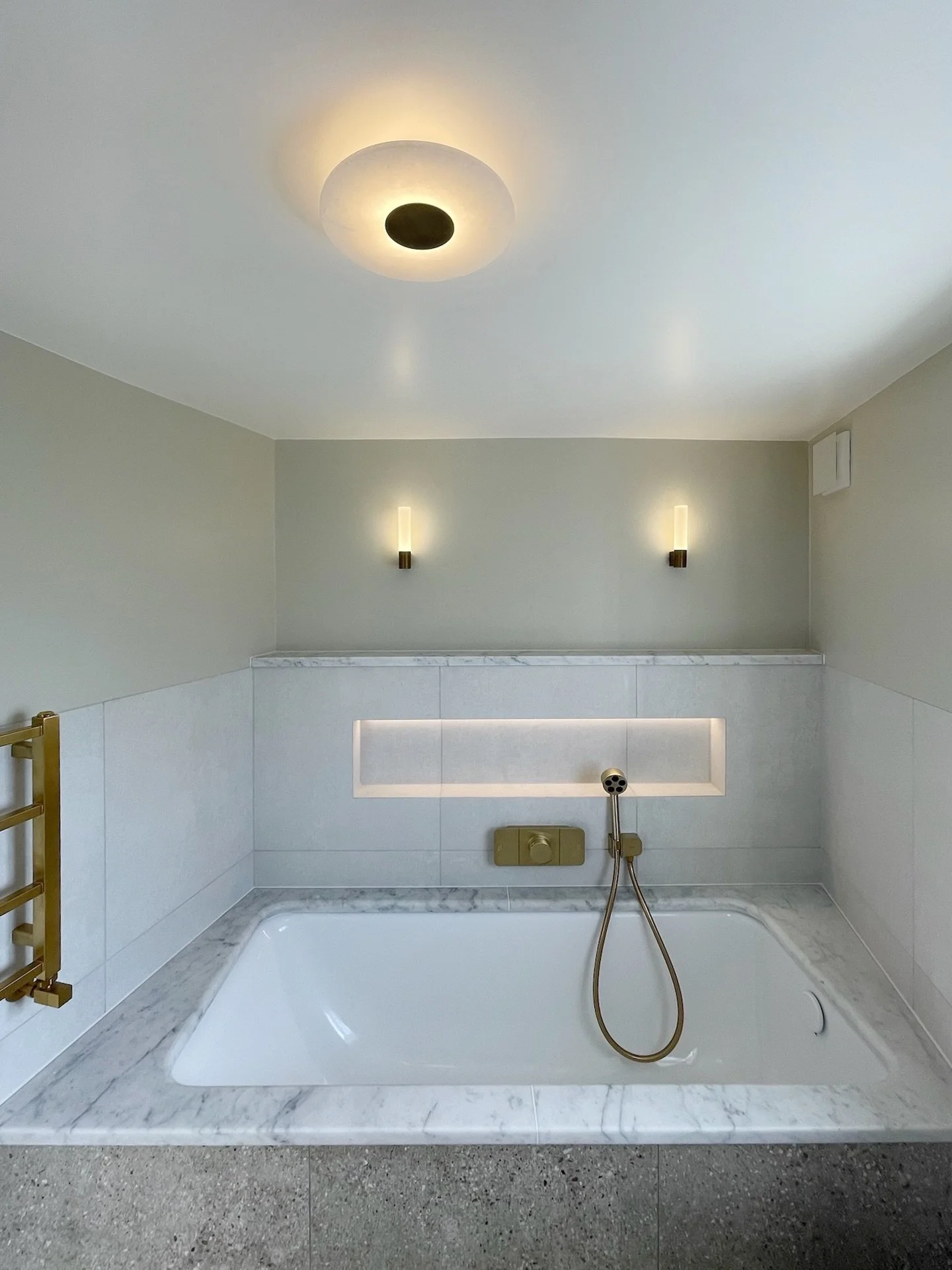 Another bathroom is complete!
Fully designed, detailed and delivered by our team.
Soft stone tones, brushed brass fixtures, and subtle integrated lighting create a refined and calming atmosphere. The marble trim continues through the ledge and bath