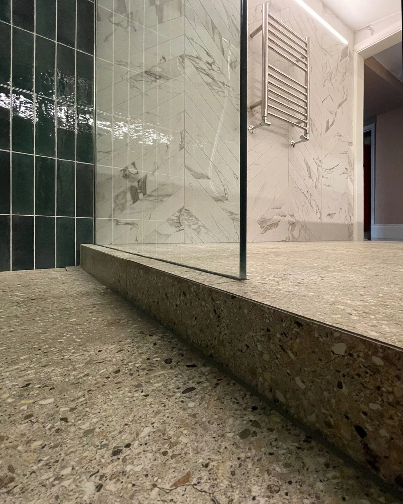 Small, elegant details define our latest vaulted bathroom at King&rsquo;s Cross.
The shower floor has been formed with an envelope fall, a subtle four-way gradient directing water precisely towards a linear drain. It is a technical requirement, but h