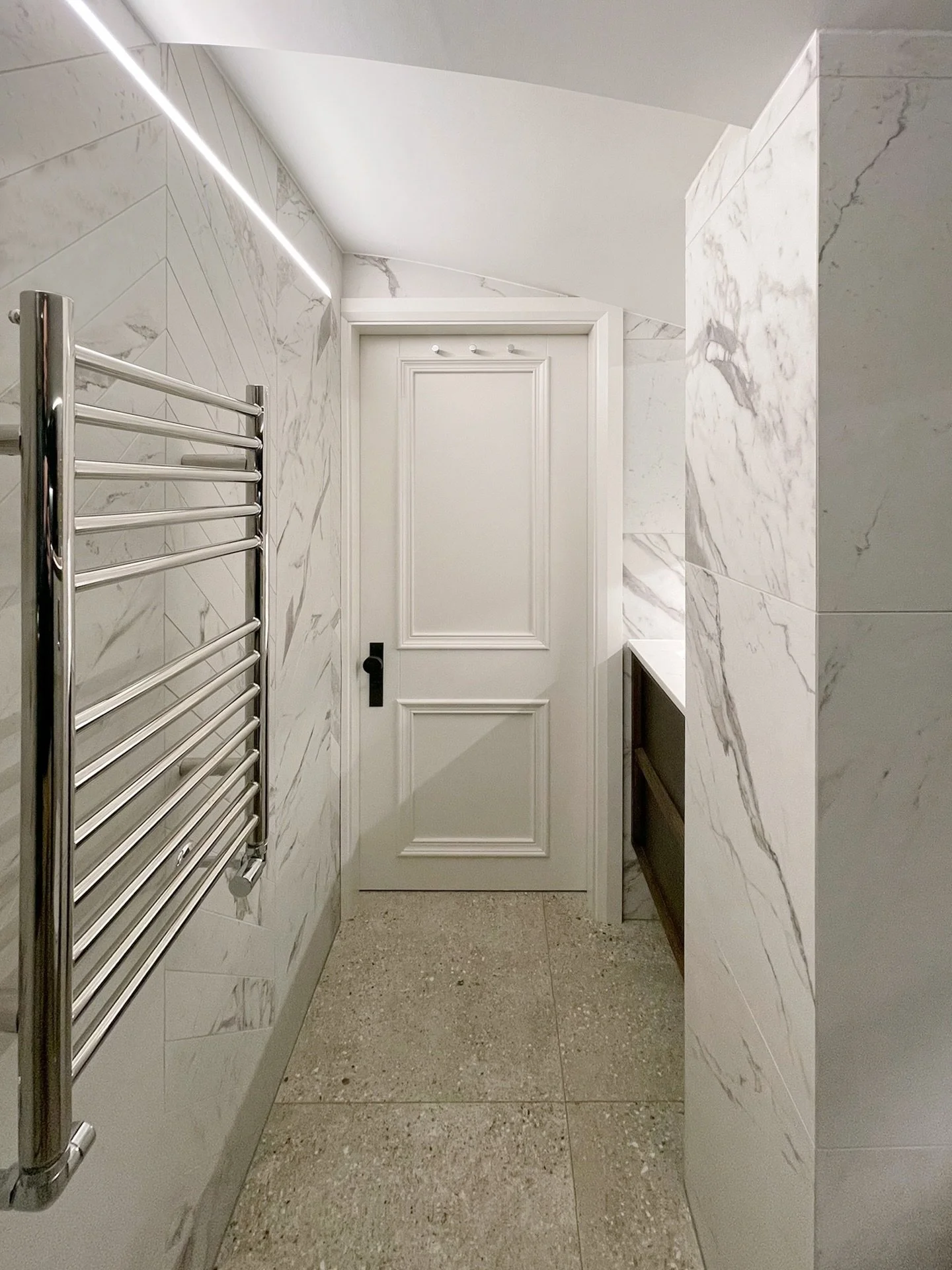 A once dark and enclosed bathroom, now completely reimagined into a calm, light filled space within our ongoing King&rsquo;s Cross project.
The vaulted ceiling helped create volume, while carefully integrated linear lighting draws the eye upward and 