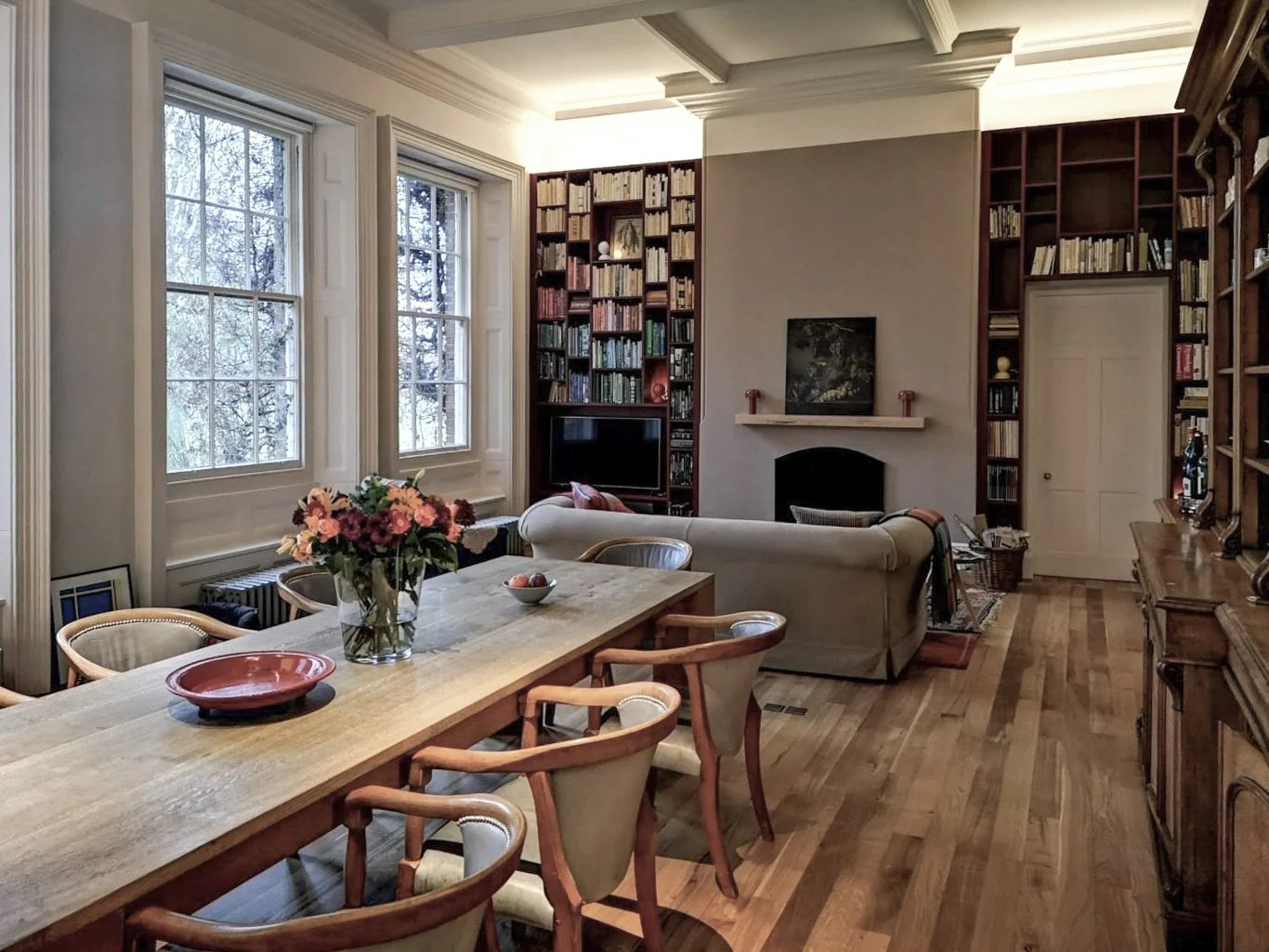 Restored living room with fireplace at Barton Court by PELHAM & Co.